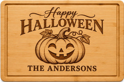 Personalized Halloween cutting board engraved with a jack o lantern, fall leaves and family name on bamboo